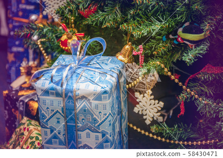 A variety of wrapped gifts under a festively 58430471