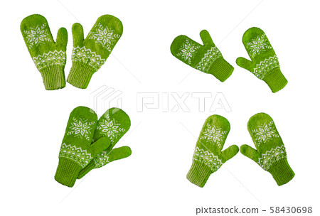 pair of green knitted mittens with christmas 58430698
