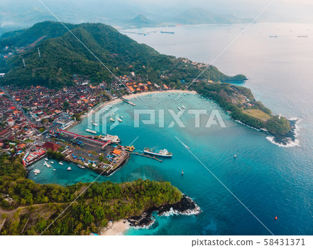 Balinese village with port, ferry ship and blue ocean. Aerial view 58431371