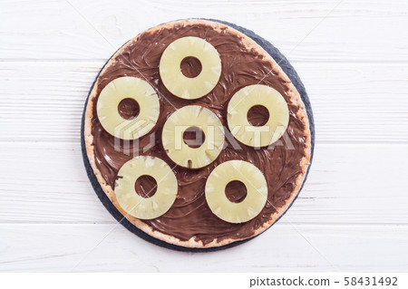 Fruit pizza with nut nougat cream and pineapple 58431492