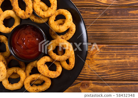 Crunchy fried onion rings and ketchup 58432348