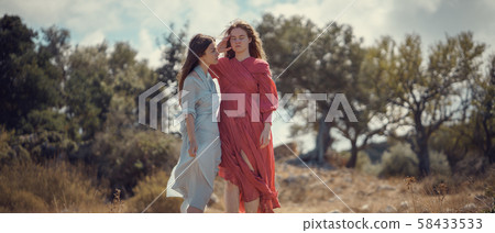 Portrait of two girls in dresses on the nature Portrait of two girls in dresses on the nature 58433533