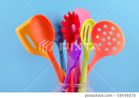 bright multi colored kitchen utensils on blue background bright multi colored kitchen utensils on blue background 58436878