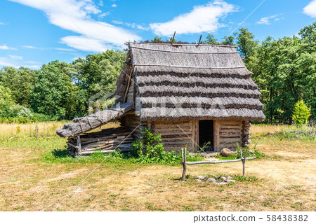 Small shepherd hut with straw roof on sunny day 58438382