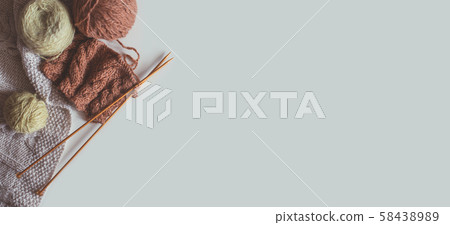 Woolen yarn and knitting needles on grey backdrop Woolen yarn and knitting needles on grey backdrop 58438989