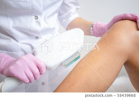 Laser hair removal on women's legs . white background close up Laser hair removal on women's legs . white background close up 58439668