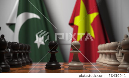 Flags of Pakistan and Vietnam behind pawns on the chessboard. Chess game or political rivalry Flags of Pakistan and Vietnam behind pawns on the chessboard. Chess game or political rivalry 58439941