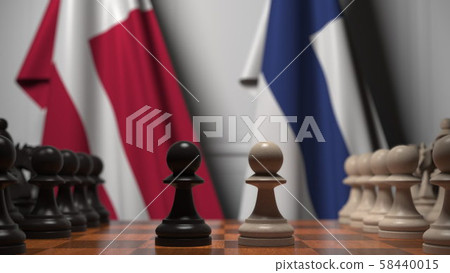 Flags of Denmark and Finland behind pawns on the chessboard. Chess game or political rivalry related Flags of Denmark and Finland behind pawns on the chessboard. Chess game or political rivalry related 58440015