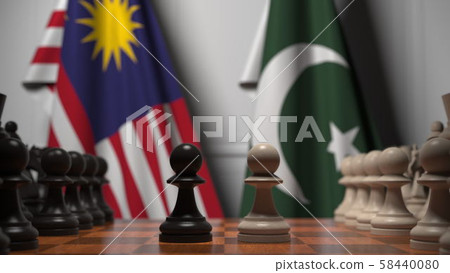 Flags of Malaysia and Pakistan behind pawns on the chessboard. Chess game or political rivalry Flags of Malaysia and Pakistan behind pawns on the chessboard. Chess game or political rivalry 58440080