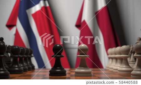 Flags of Norway and Denmark behind pawns on the chessboard. Chess game or political rivalry related Flags of Norway and Denmark behind pawns on the chessboard. Chess game or political rivalry related 58440588
