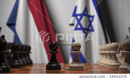 Flags of Netherlands and Israel behind pawns on the chessboard. Chess game or political rivalry 58441076