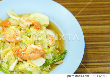 Fried vegetables with shrimp on white dish 58442912