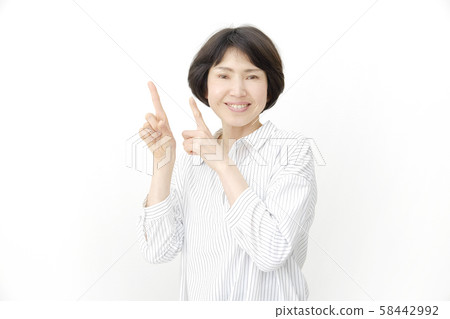 Female middle age finger pointing Female middle age finger pointing 58442992