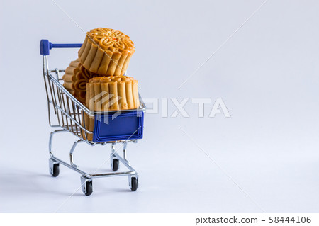 Shopping cart with mooncakes on white background. Shopping cart with mooncakes on white background. 58444106