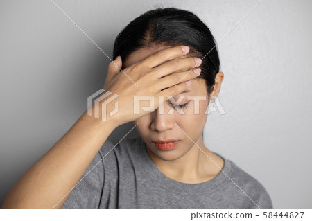 Young woman with of stress and headaches. Young woman with of stress and headaches. 58444827