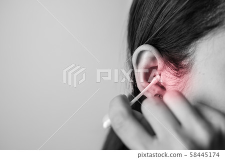 Concept of cleaning in the ear hole. Concept of cleaning in the ear hole. 58445174