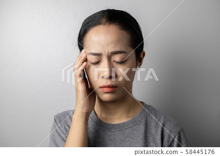 Young woman with of stress and headaches. 58445176