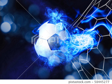 A soccer ball that breaks through the goal net A soccer ball that breaks through the goal net 58445277