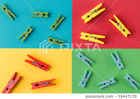 Little wooden clothespins on colorful paper background. 58447170