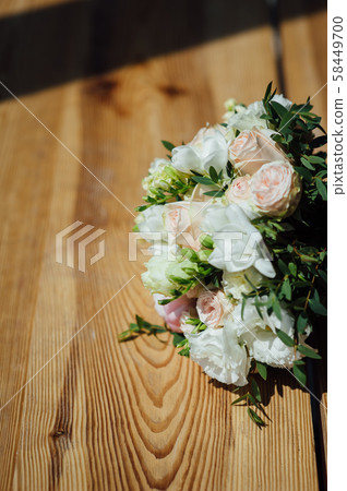 Wedding bouquet from beautiful flowers: pink roses, white and pink ranunculus 58449700