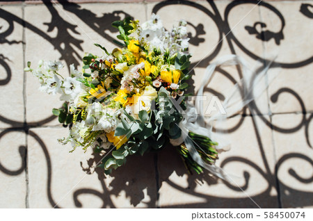 Wedding bouquet from beautiful flowers: pink roses, white and pink ranunculus 58450074
