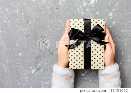 Girl Hands holding craft paper gift box with as a Girl Hands holding craft paper gift box with as a 58451052