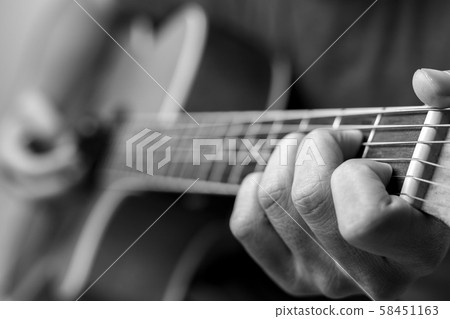 Musicians are playing acoustic guitar. 58451163