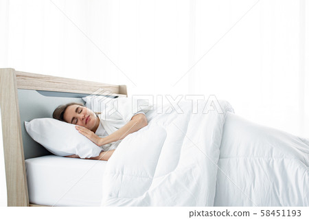 Young beautiful sleep in the bed at home. 58451193