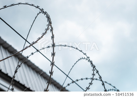 Barbed wire fences installed on the wall to protect the area from thieves or prevent prisoners escape. 58451536