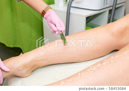 Application of contact gel before laser hair removal procedure. Preparation of the skin surface for Application of contact gel before laser hair removal procedure. Preparation of the skin surface for 58453084