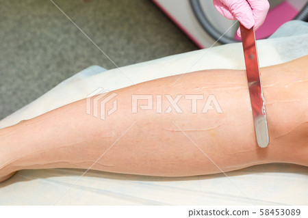 Application of contact gel before laser hair removal procedure. Preparation of the skin surface for Application of contact gel before laser hair removal procedure. Preparation of the skin surface for 58453089