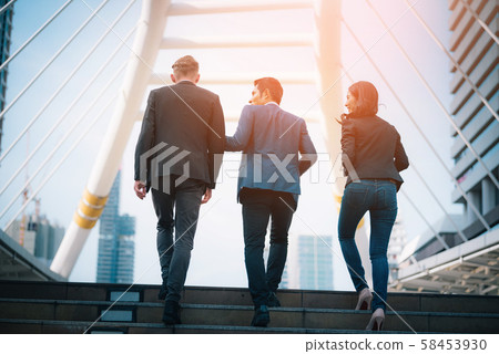 Rear view of business team climbing stairs go to a Rear view of business team climbing stairs go to a 58453930