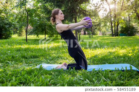 Beautiful woman doing Pilates in the green park 58455189