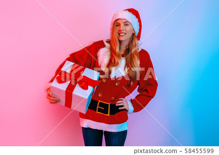 Happy girl in Santa hat holding big gift box 58455599