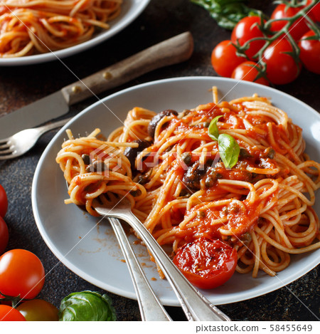 Spaghetti with tomato sauce olives and capers 58455649