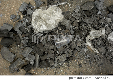 The problem of ecology, forest fires and plastic pollution, disposable tableware.Coal and plastic. The problem of ecology, forest fires and plastic pollution, disposable tableware.Coal and plastic. 58458139