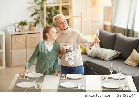 Family wiping the wineglasses 58458144