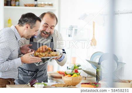 Men preparing roast turkey Men preparing roast turkey 58458231