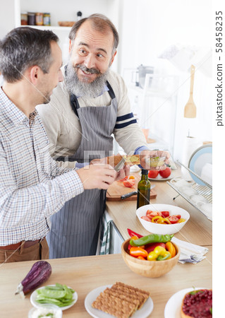 Father and son cooking in the kitchen Father and son cooking in the kitchen 58458235