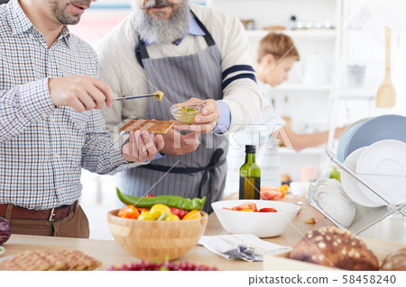 Man tasting sauce in the kitchen Man tasting sauce in the kitchen 58458240