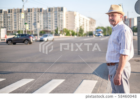 Mature european man waiting to cross street 58460048