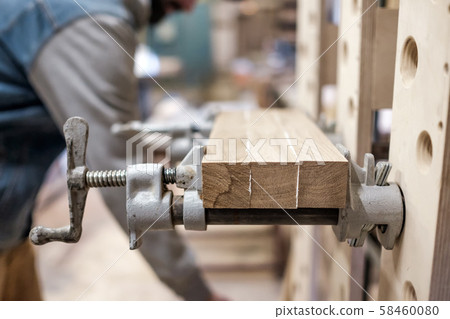 Connecting wooden timbers for furniture detail with special glue. 58460080