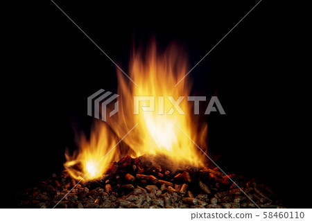 detail of wood pellets burning in a stove. detail of wood pellets burning in a stove. 58460110