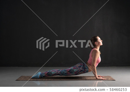 woman practicing yoga, doing urdhva mukha svanasana, upward facing dog pose woman practicing yoga, doing urdhva mukha svanasana, upward facing dog pose 58460253