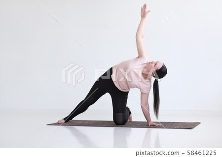 woman doing Side Plank Posture, Pose of Vashista, Vasisthasana woman doing Side Plank Posture, Pose of Vashista, Vasisthasana 58461225