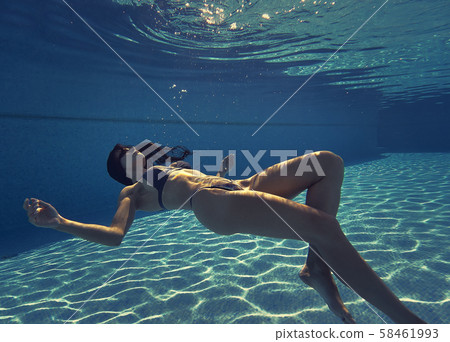 Woman swimming on the depth of pool Woman swimming on the depth of pool 58461993