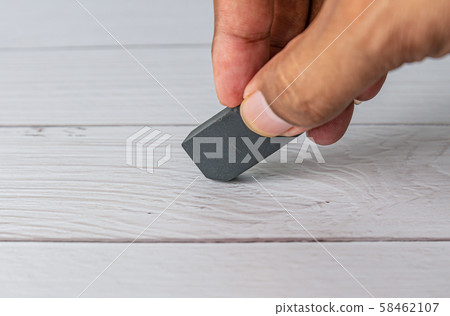 Eraser and error concept, Hand with black eraser 58462107