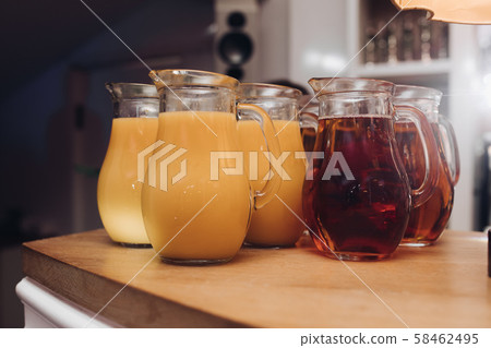 Delicious juices in jars on table.Several jars of Delicious juices in jars on table.Several jars of 58462495
