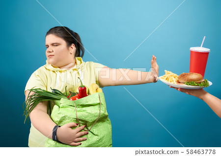 Chunky brunette girl refusing fastfood on her life 58463778