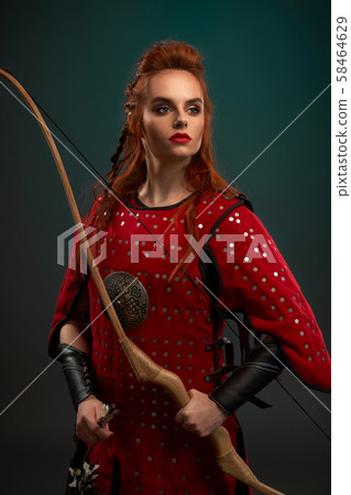 Portrait of attractive female warrior wearing red armor Portrait of attractive female warrior wearing red armor 58464629